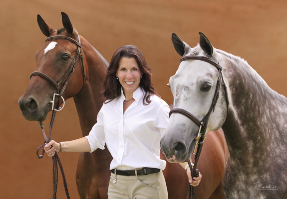 Portrait of a woman with her bay and dappled horses